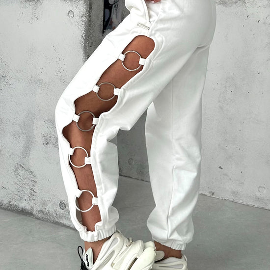 White cut-out joggers by KRUTYAKOV with five-ring side details and relaxed high-waist fit