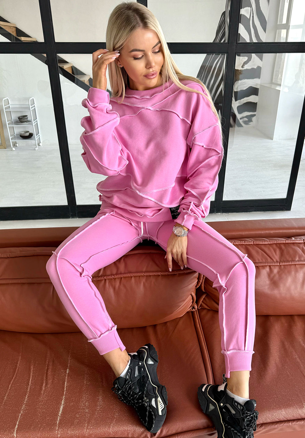Women’s pink reverse seam tracksuit by KRUTYAKOV — Inva two piece set with bold white exposed stitching and relaxed designer fit