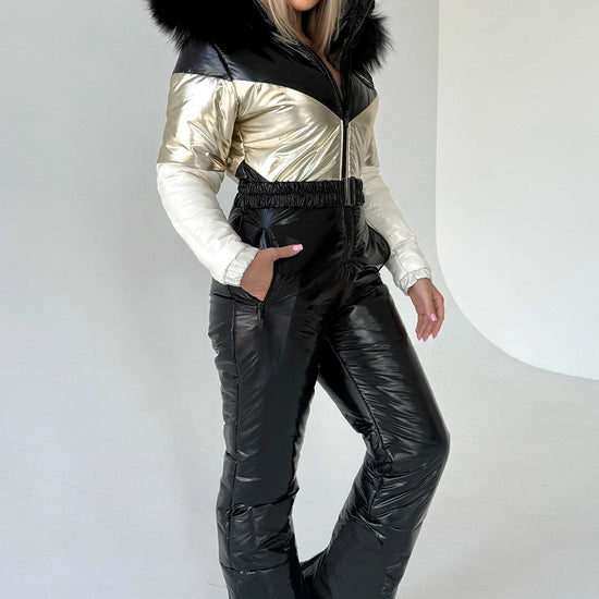 Women’s black and gold one piece ski suit by KRUTYAKOV with insulated snow suit design and detachable fur hood