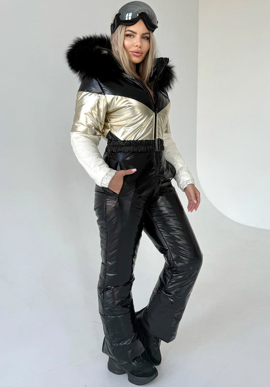 Women’s black and gold one piece ski suit by KRUTYAKOV with insulated snow suit design and detachable fur hood