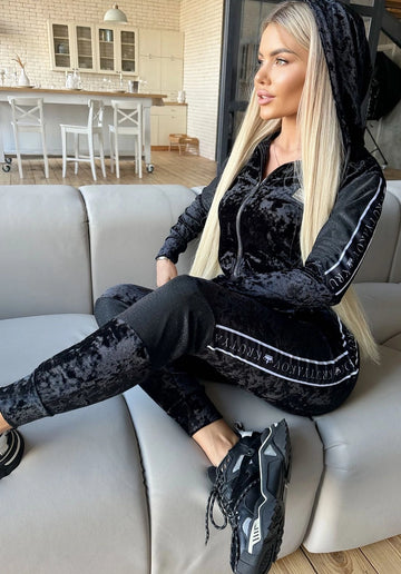 Women’s black velour tracksuit by KRUTYAKOV — premium marble-look two piece set with soft shine and branded side stripes