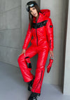 Woman in SANTA red insulated ski jumpsuit by KRUTYAKOV styled as a bold luxury winter outfit
