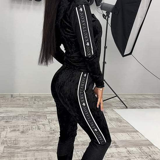 VELUREX black women’s velour tracksuit with glossy wet-look finish, zip jacket, and matching jogger pants