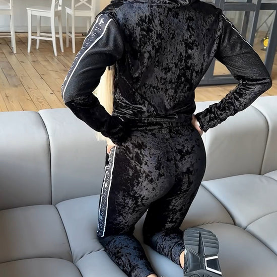 Black women’s velour jogger outfit with sleek jacket, relaxed pants, and elegant shine for elevated casual looks