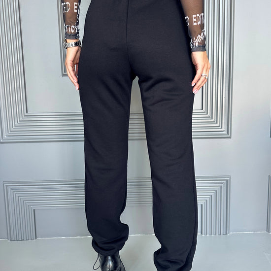 Women’s black cargo joggers with flap pockets, metal snaps, and comfortable everyday streetwear fit