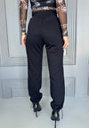 Women’s black cargo joggers with flap pockets, metal snaps, and comfortable everyday streetwear fit