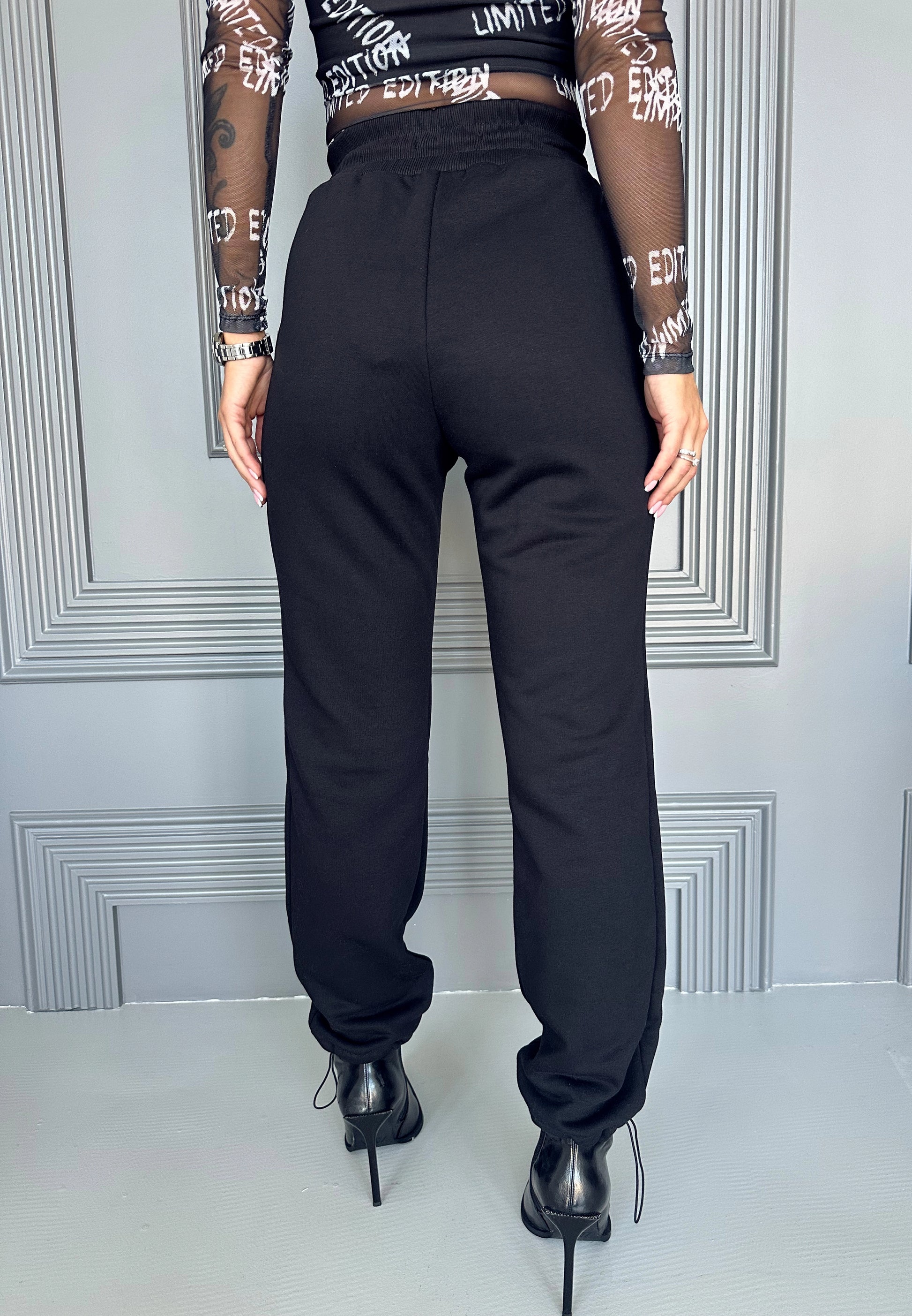 Women’s black cargo joggers with flap pockets, metal snaps, and comfortable everyday streetwear fit