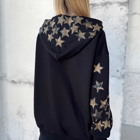 Black cotton-blend hoodie with decorative leather stars and cozy hood