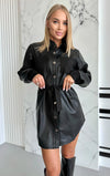 Black vegan leather dress with soft suede belt, practical patch pockets, and clean modern shirt-dress silhouette
