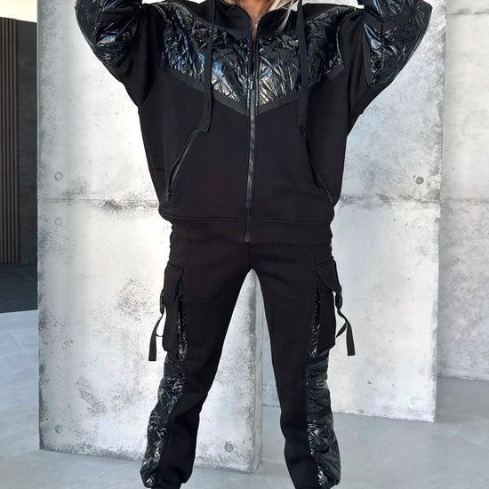 Women’s black two piece tracksuit with glossy finish, soft micro-fleece lining, and comfortable jogger fit