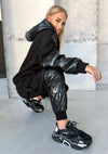 Handmade women’s black jogger set by KRUTYAKOV with subtle rubber patch branding and ergonomic seam details