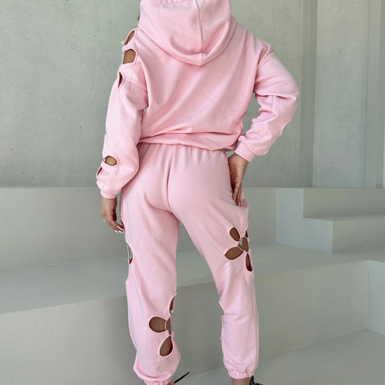 KRUTYAKOV Daisy Pink women’s tracksuit with floral cut-out detail, pastel color, and relaxed modern fit