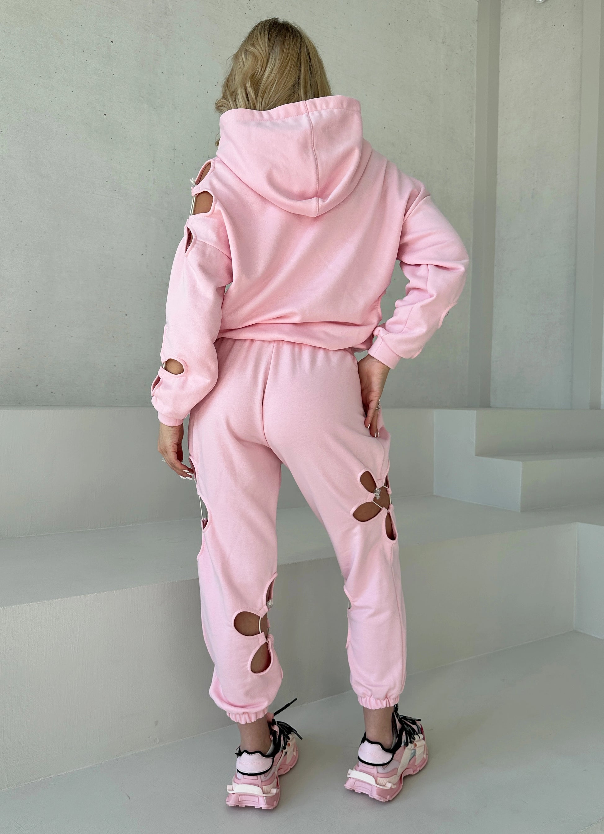 KRUTYAKOV Daisy Pink women’s tracksuit with floral cut-out detail, pastel color, and relaxed modern fit