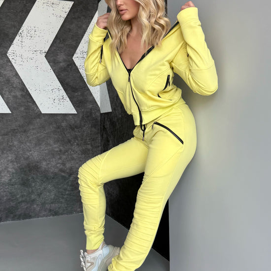 KRUTYAKOV yellow two-piece tracksuit for women with relief design details, premium finish, and comfortable silhouette