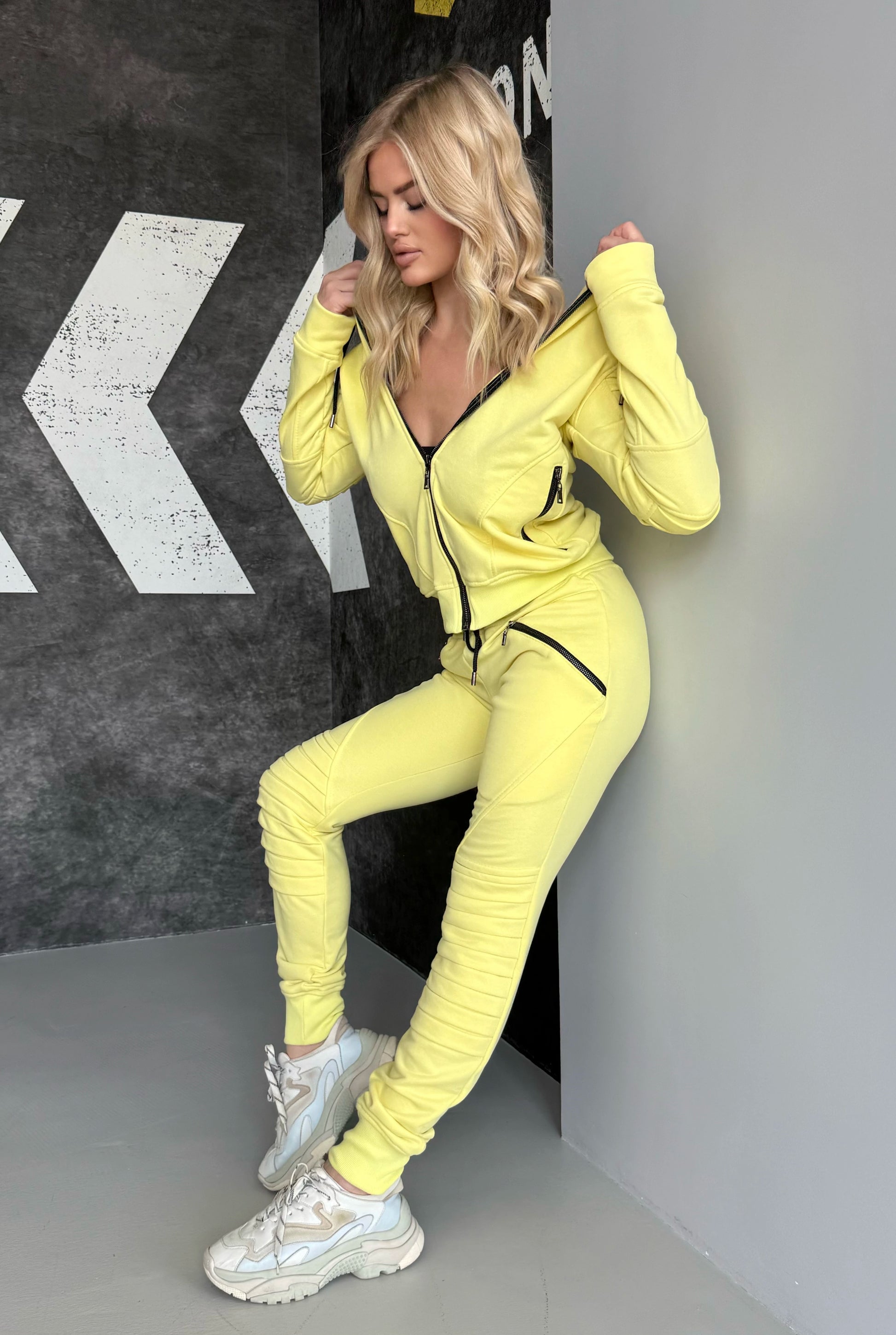 KRUTYAKOV yellow two-piece tracksuit for women with relief design details, premium finish, and comfortable silhouette