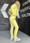 KRUTYAKOV Relief Yellow tracksuit close-up with zip pockets, soft knit texture, and bold designer streetwear details