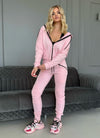 Full-body view of women’s pink tracksuit set with modern zip hoodie, joggers, and spring summer casual style