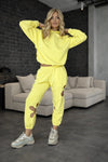 Bright yellow women’s jogger outfit with relaxed hoodie, comfortable fit, and modern streetwear aesthetic