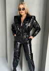 Women’s black statement jumpsuit styled for night out, party, and streetwear looks