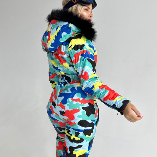 Back view of women’s one piece ski suit with multicolored print, detachable hood, and comfortable winter fit