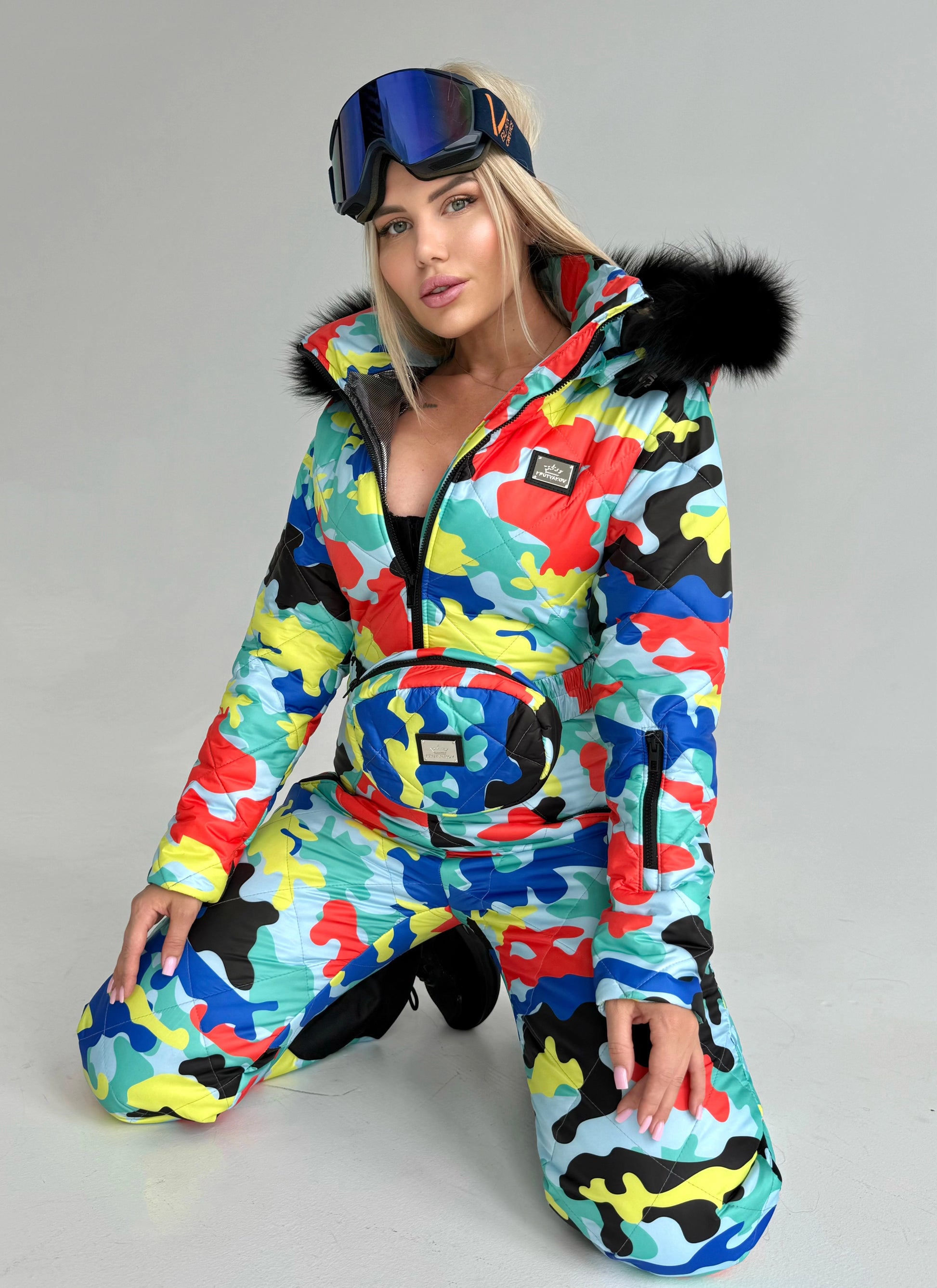 KRUTYAKOV women’s one piece snow suit in colorful designer print for skiing, snowboarding, and après-ski looks