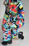 Women’s designer ski overall with bold multicolor print, premium zippers, and luxury resort outfit style