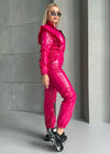 Side view of hot pink shiny jumpsuit with sleek body-contouring fit