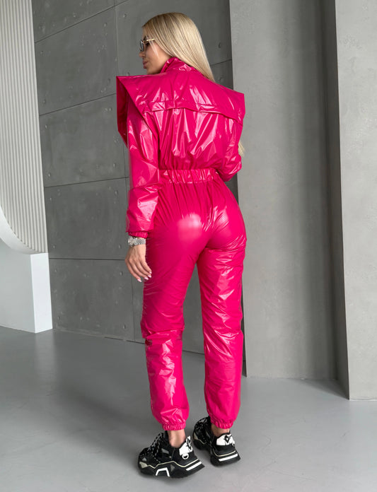 Women’s shiny hot pink jumpsuit with sculpted fitted silhouette and long sleeves