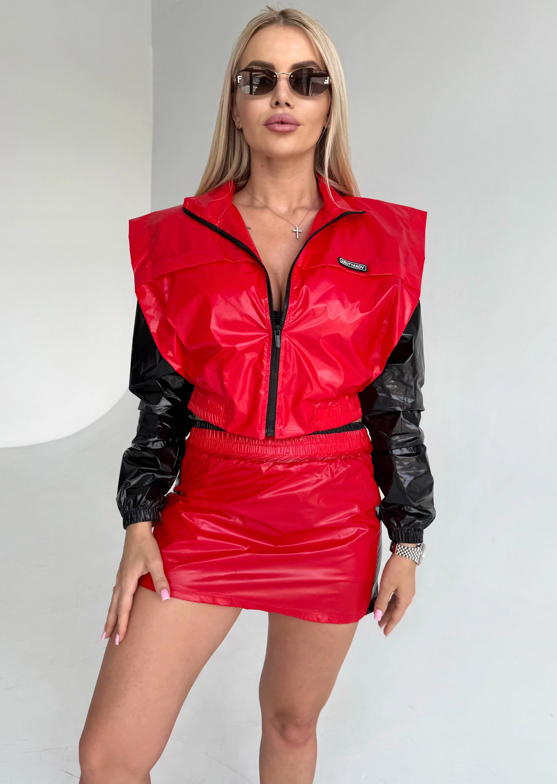 Red black party outfit for women with glossy PVC-look fabric and structured cropped jacket