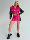 Women’s glossy festival outfit with cropped jacket, mini skirt and streetwear silhouette