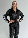 Women’s glossy black two piece tracksuit with branded side stripes and fitted streetwear silhouette
