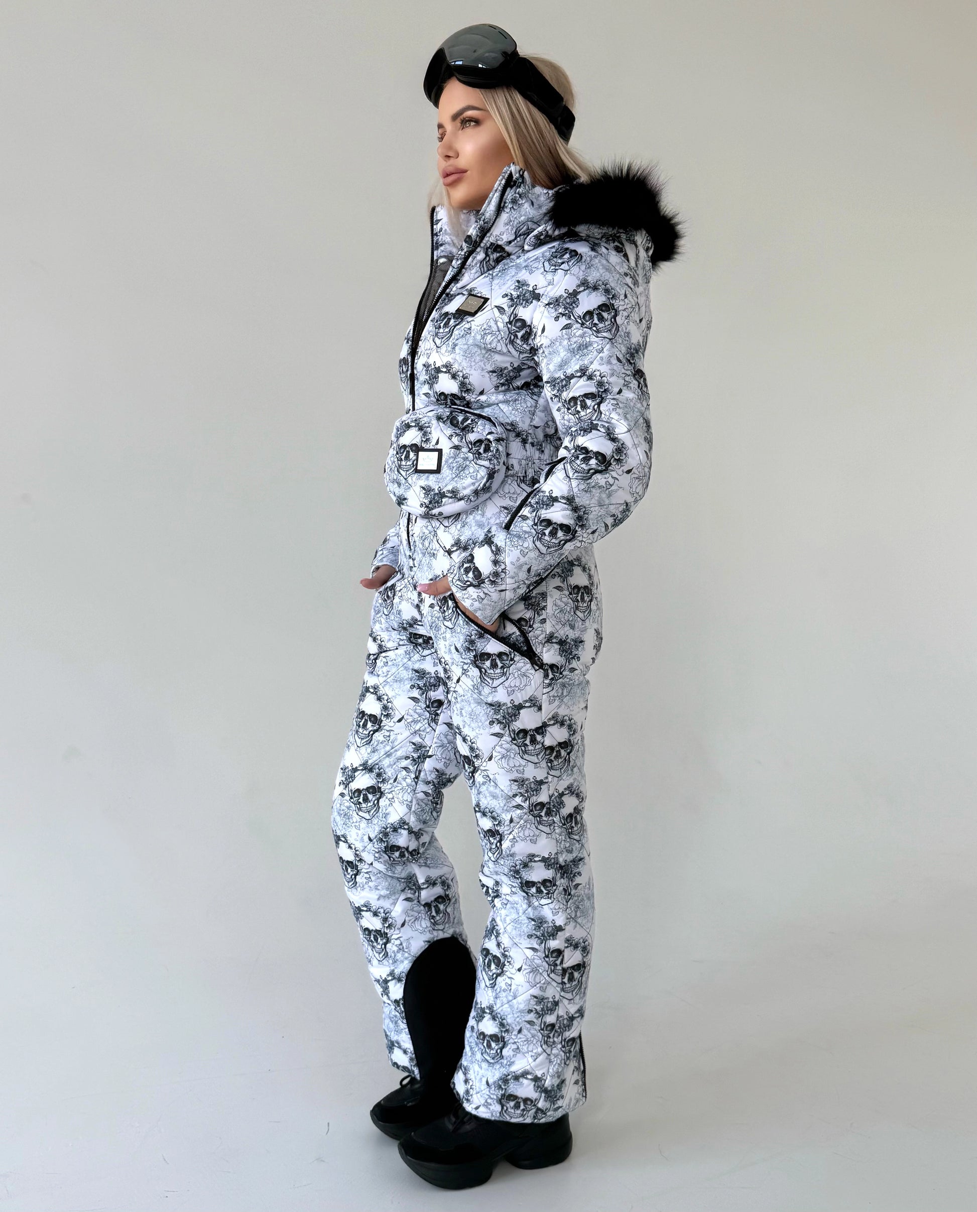 Women’s insulated ski jumpsuit with waterproof-look outer shell, functional pockets, and luxury winter styling