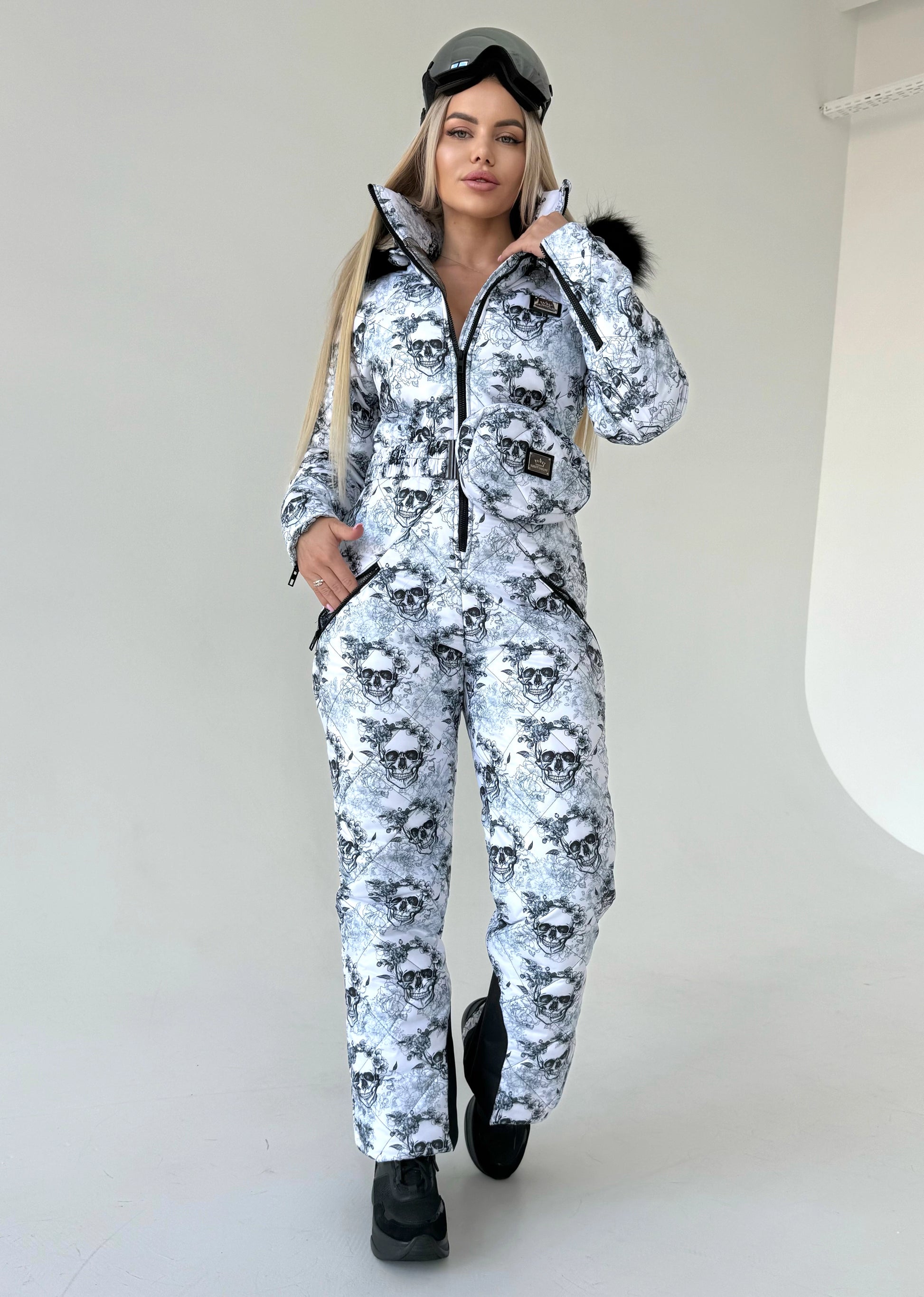 KRUTYAKOV skull print ski suit for women with warm lining, fitted shape, and statement winter fashion look