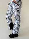 Women’s black white skull snowsuit styled for ski resorts, snowboarding trips, and winter mountain vacations
