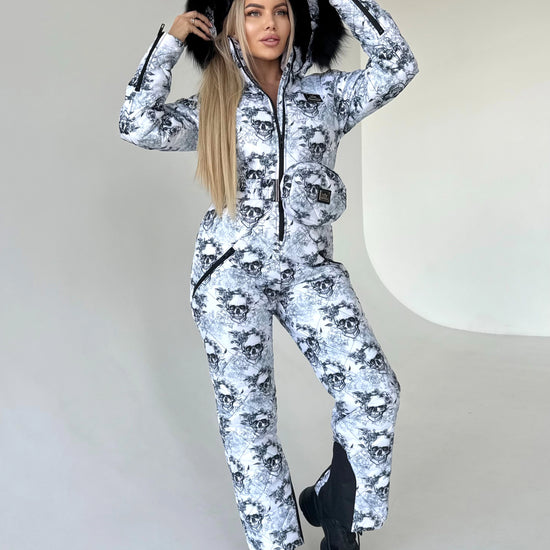 Back view of KRUTYAKOV one piece ski suit with detachable hood, belt bag, and bold designer print