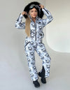 Back view of KRUTYAKOV one piece ski suit with detachable hood, belt bag, and bold designer print