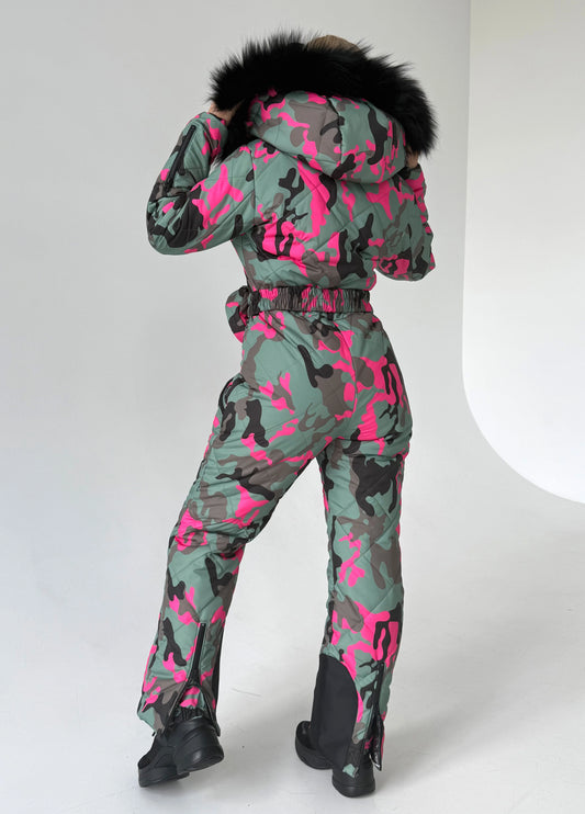 Full-body view of VALE pink camouflage snowsuit with fitted silhouette, insulated construction, and belt bag