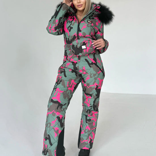 Back view of pink camo ski jumpsuit showing full one piece construction, warm lining, and resort-ready silhouette