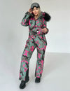 Back view of pink camo ski jumpsuit showing full one piece construction, warm lining, and resort-ready silhouette