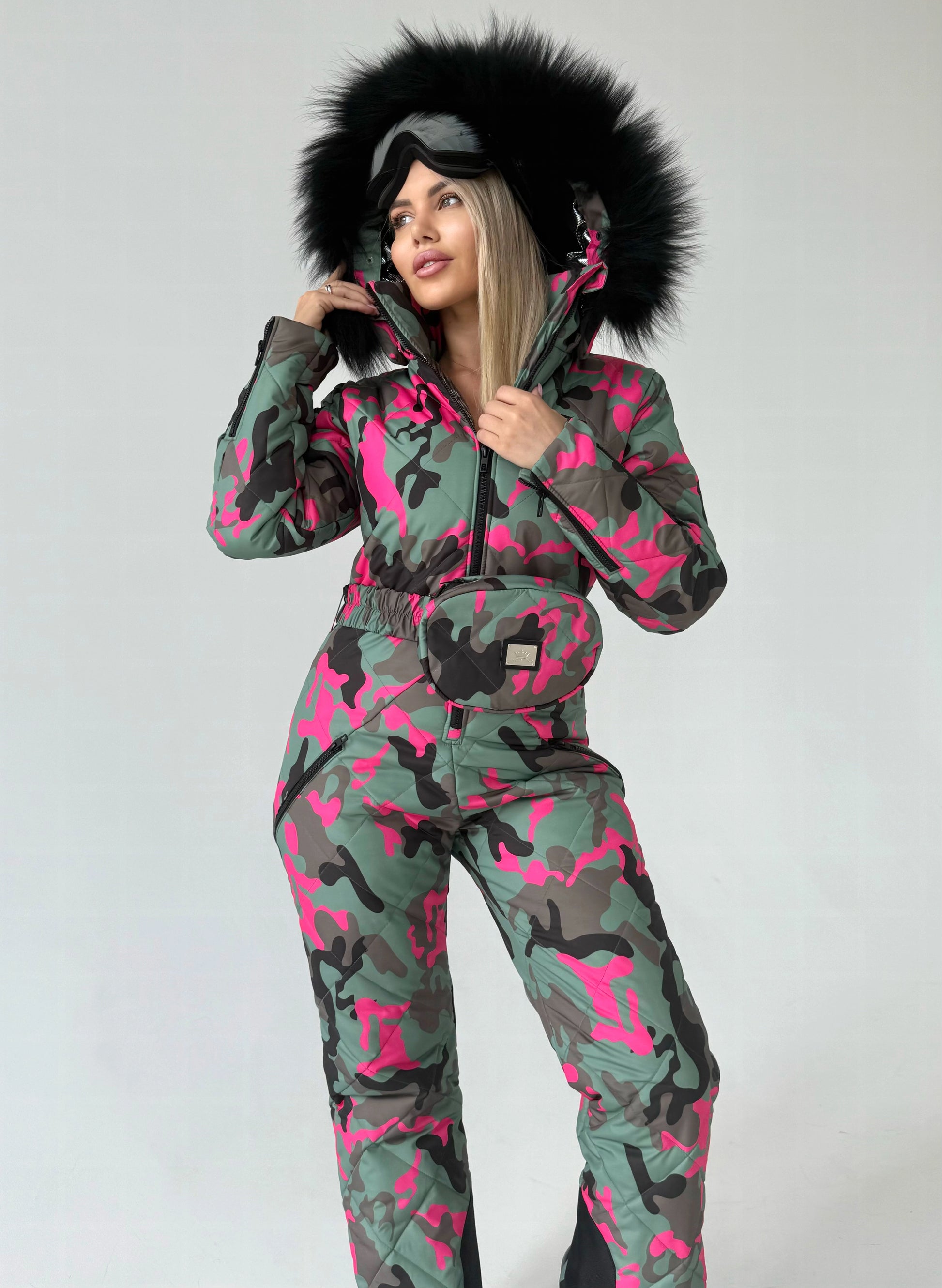 VALE luxury ski suit for women with faux fur hood, matching belt bag, and statement winter fashion look