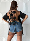 Front view of black designer T-shirt with minimalist cut, metal chain trim, and premium cotton fabric