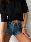 Front view of women’s black ROSETTE t-shirt with sculptural rose detail and soft cotton stretch fabric