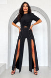 Black lace-up slit pants by KRUTYAKOV for statement fashion and special occasions