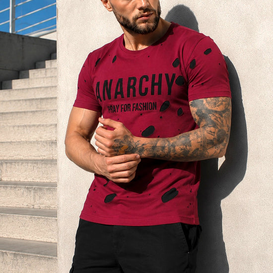 Front view of men’s burgundy designer T-shirt with ANARCHY and PRAY FOR FASHION print