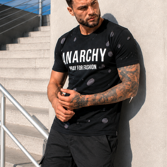 Front view of men’s black designer T-shirt with ANARCHY and PRAY FOR FASHION print