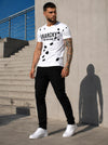 Male model wearing a white ANARCHY graphic T-shirt with black pants and white sneakers