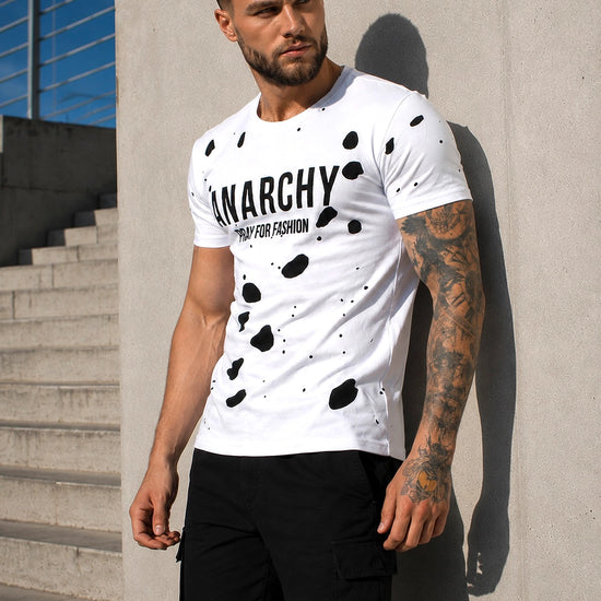 Close-up of men’s white designer T-shirt with ANARCHY velvet-effect print and layered cut-out design