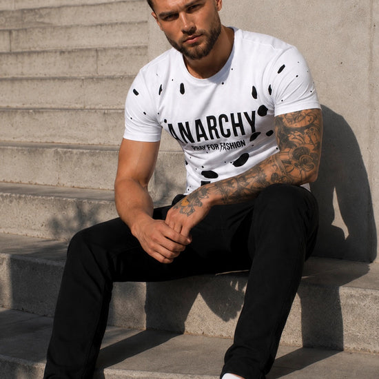 Back view of men’s white ANARCHY T-shirt with black decorative cut-out details
