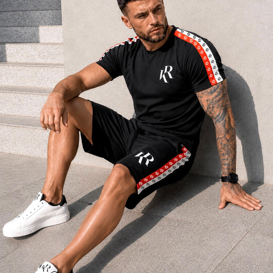 KRUTYAKOV men’s black t-shirt and shorts summer set with branded logo tape, worn with white sneakers for a streetwear vacation look
