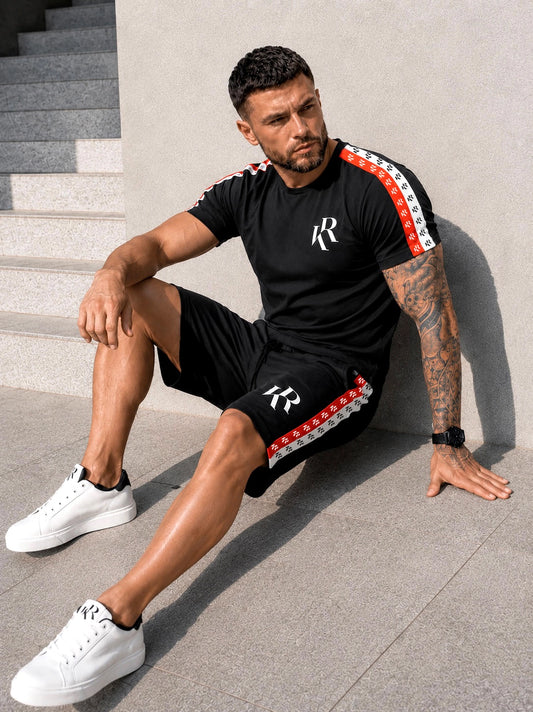 KRUTYAKOV men’s black t-shirt and shorts summer set with branded logo tape, worn with white sneakers for a streetwear vacation look